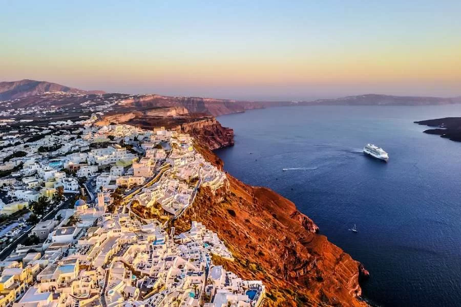 Santorini, Greek Island - Aerial Photo of White Buildings Near a Bay